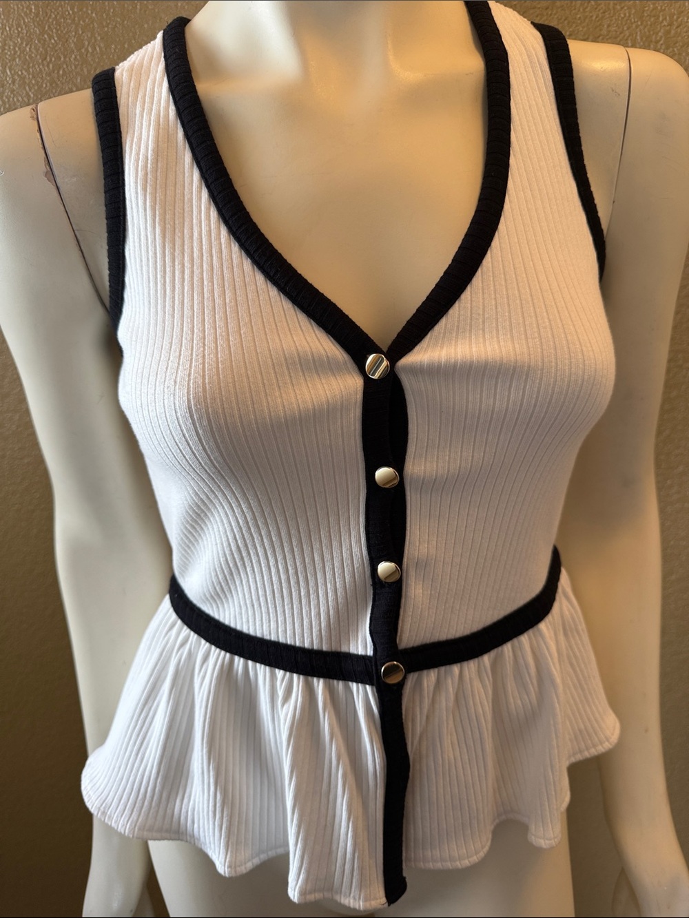 Sleeveless White Ribbed Peplum Top with Black Trim
